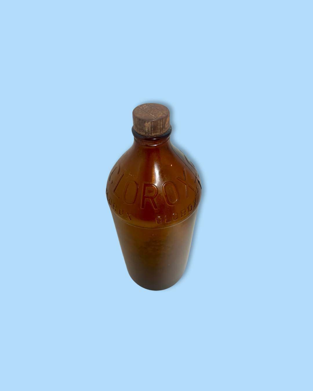 Brown bottle with cap on a light blue background