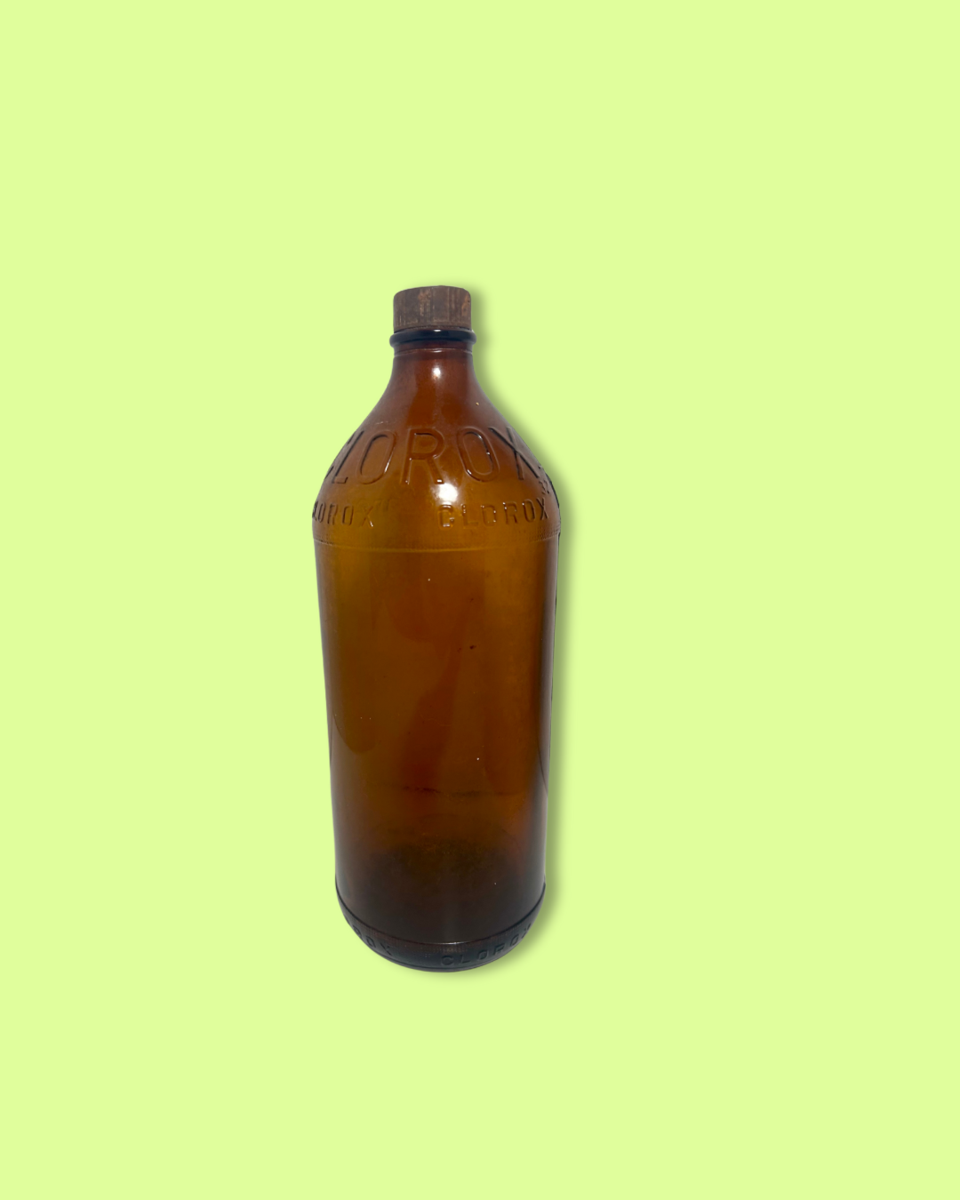 Brown glass bottle with cap on a light green background
