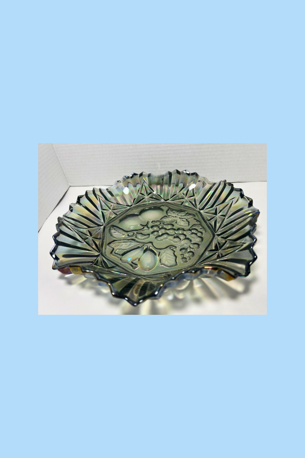 Decorative glass bowl with leaf design on a white surface