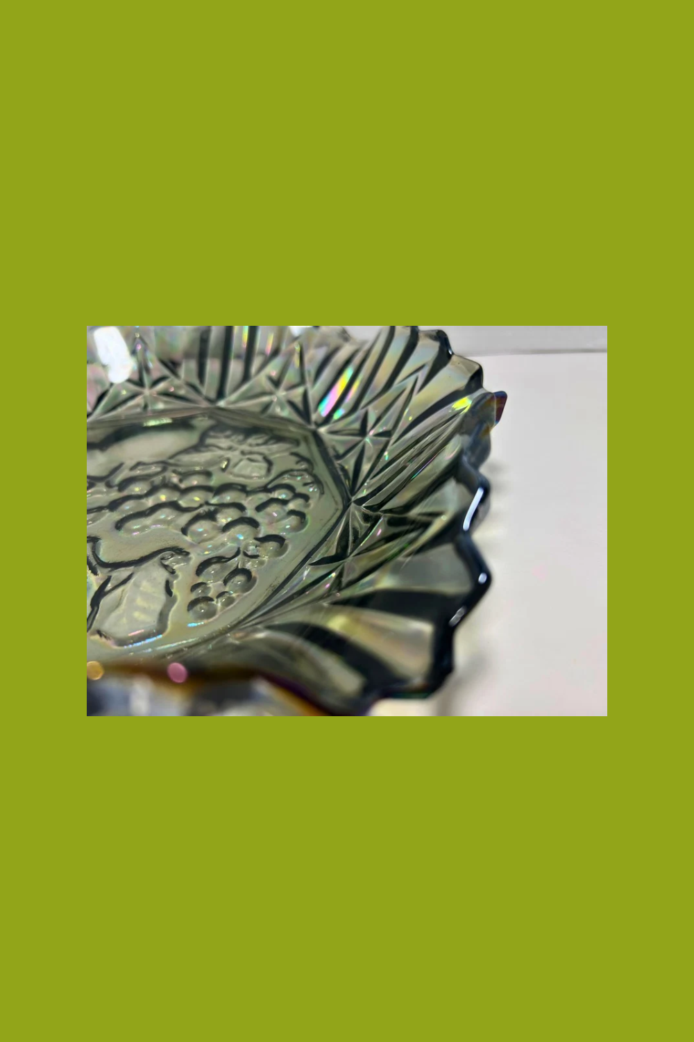 Decorative metal object with intricate design on a green background