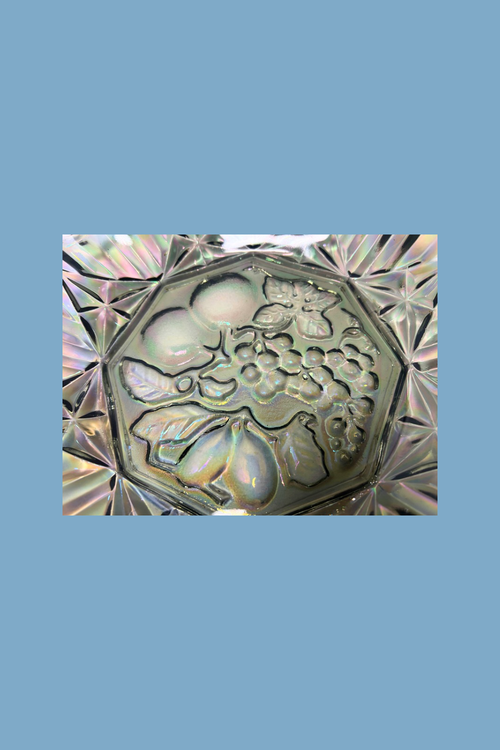 Decorative glass bowl with floral patterns on a blue background