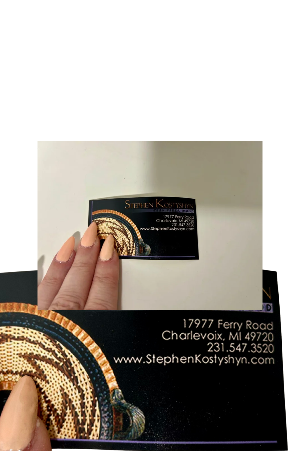 Hand holding a business card with detailed design and text