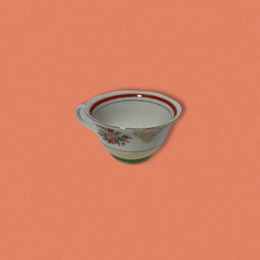 Photo of hand-painted Japanese tea cup on orange background