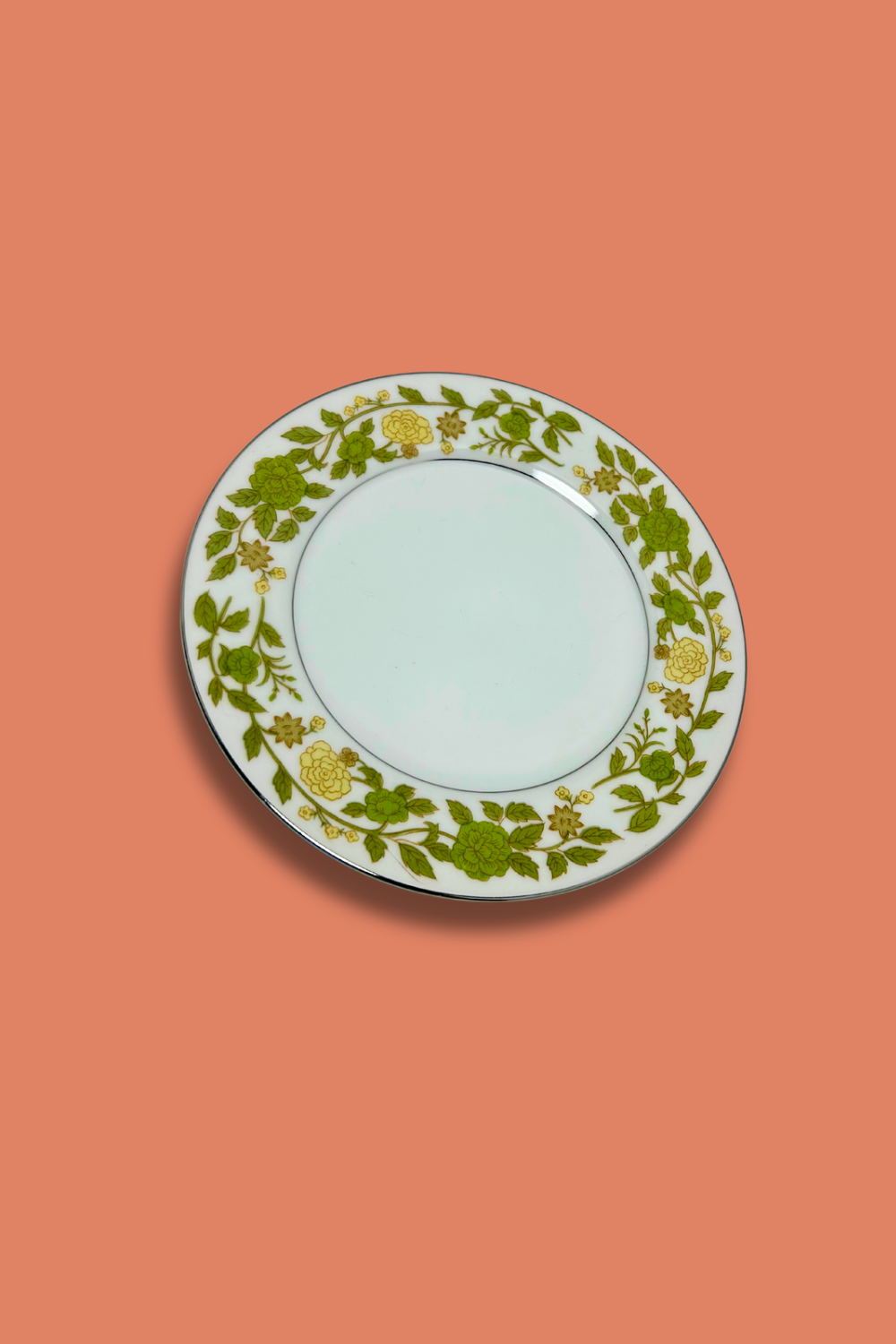 Decorative plate with floral pattern on a coral background