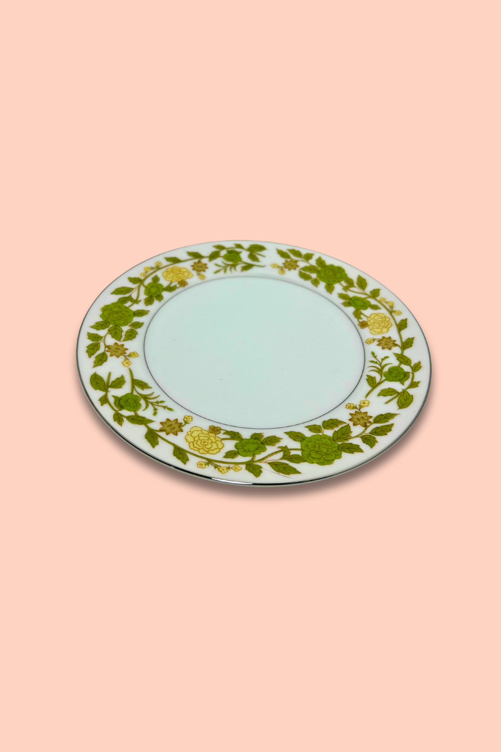 Decorative plate with floral pattern on a pink background