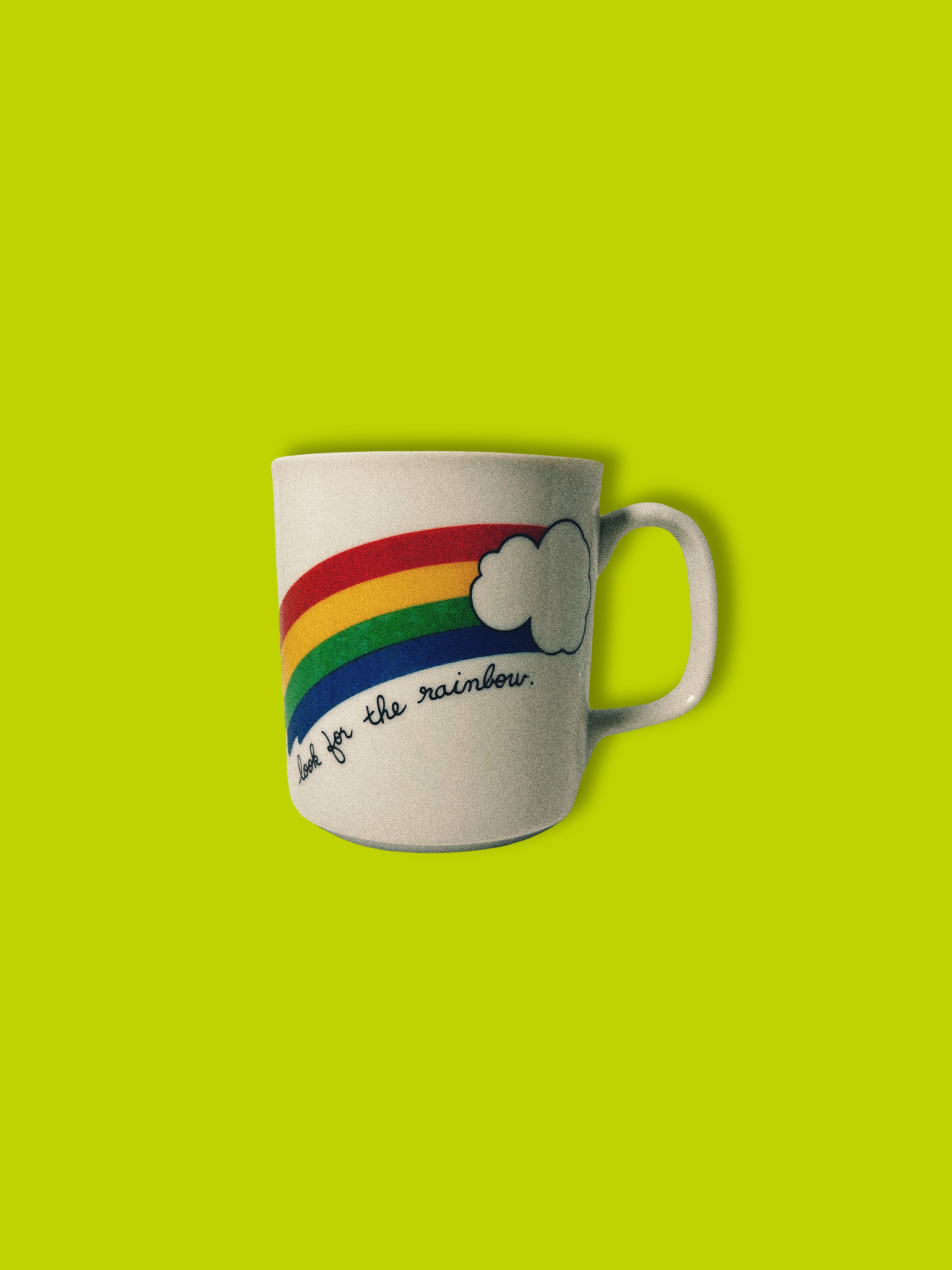 White ceramic mug with rainbow and positive quote.
