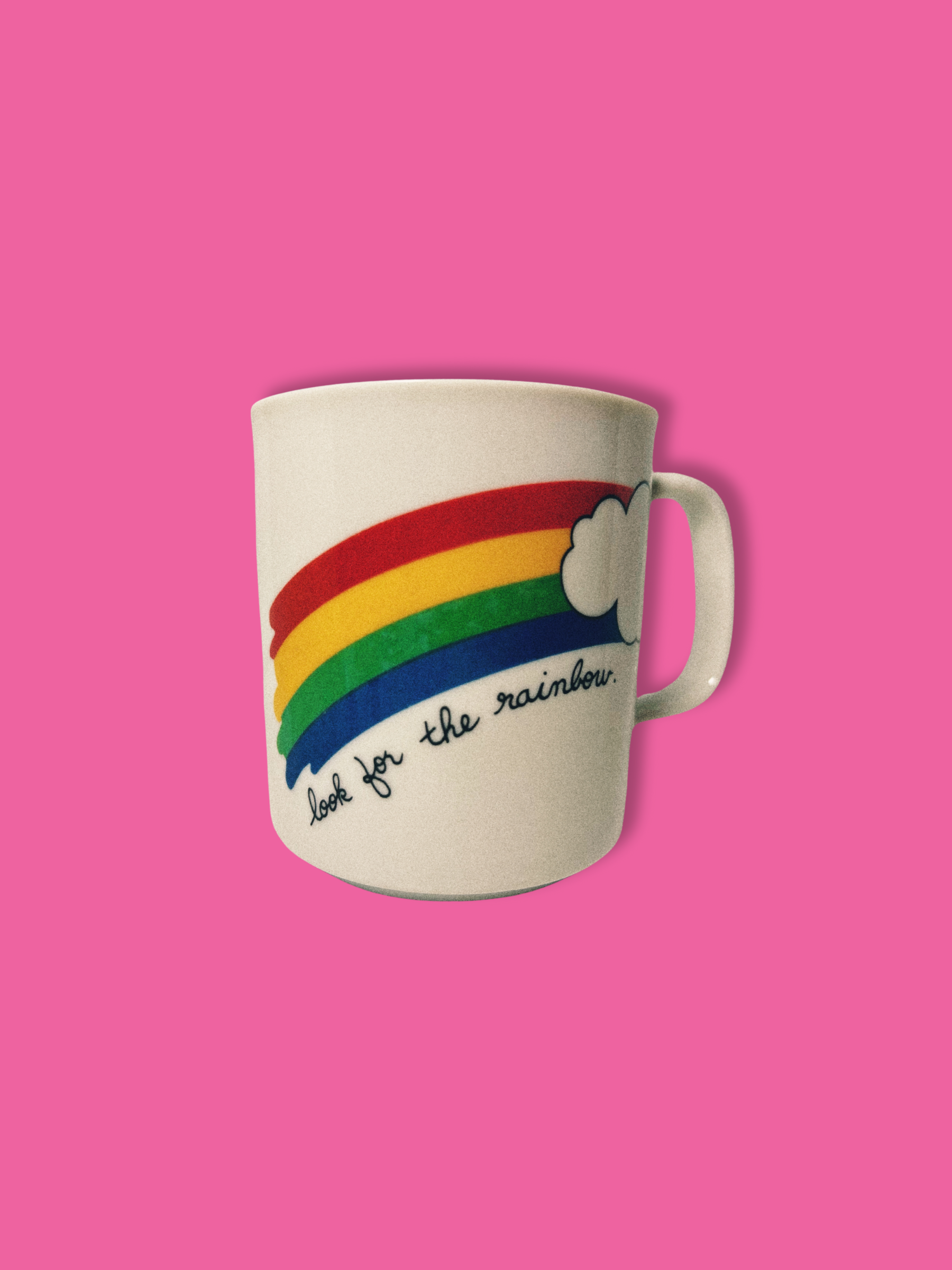 White ceramic mug with rainbow and positive quote.