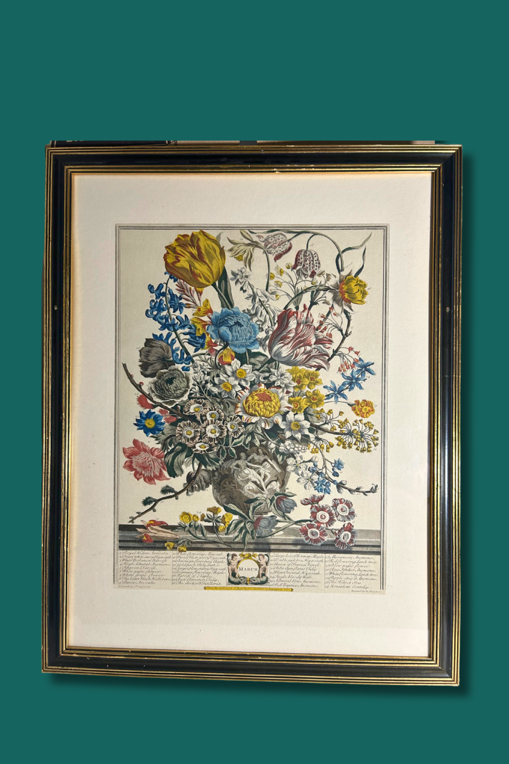 Framed artwork of a floral arrangement on a green background