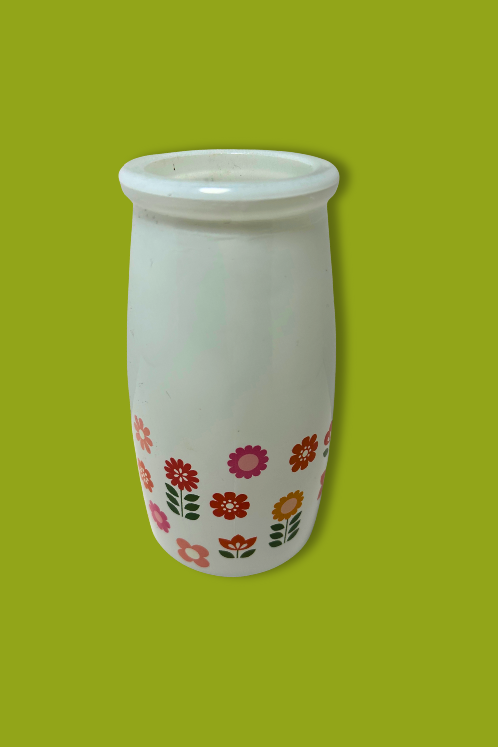 White vase with floral patterns on a green background