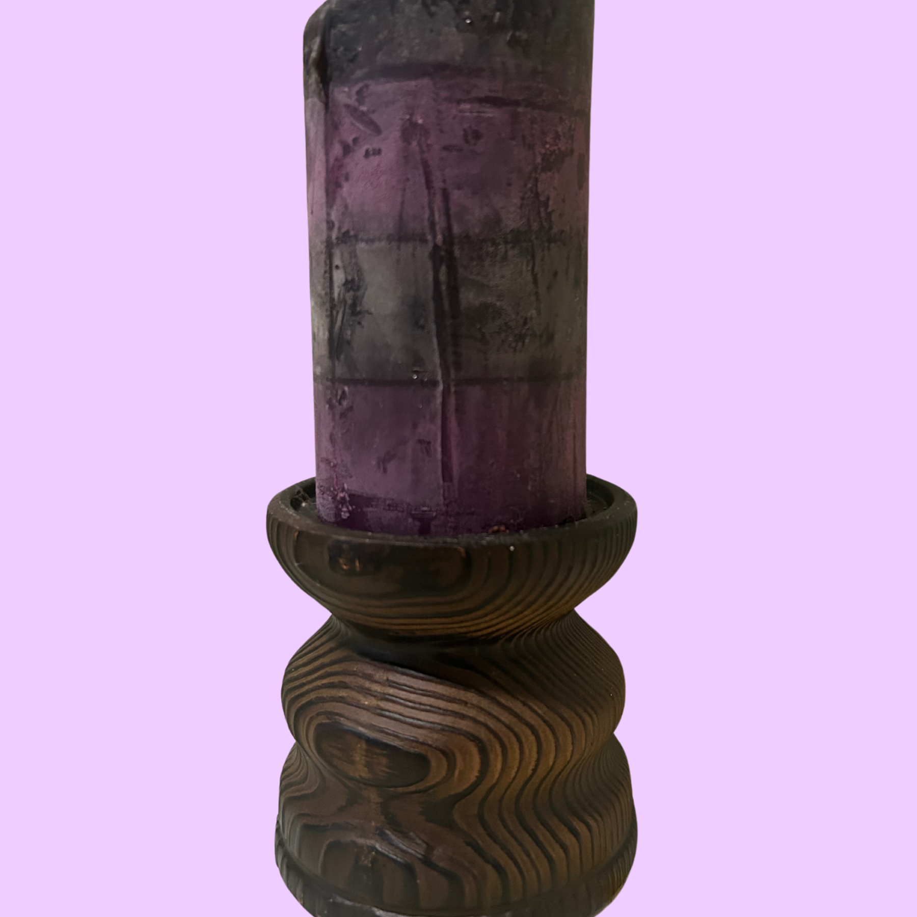 A brown Japanese clay wooden candle riser with a cylindrical shape, displayed against a purple background.