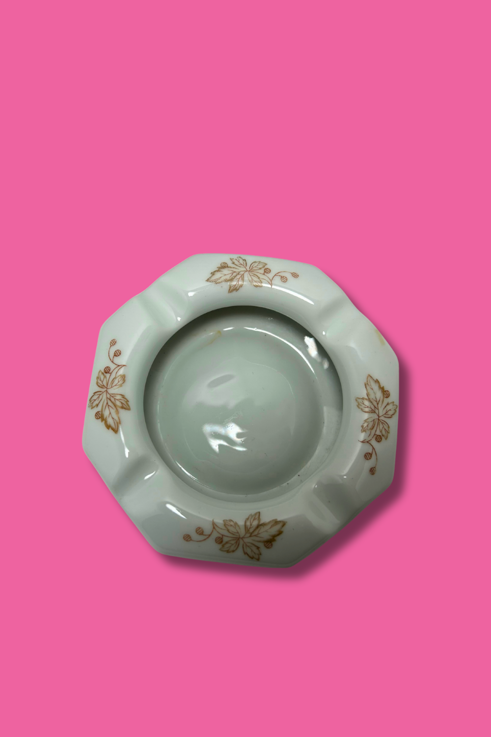 Decorative ashtray with floral patterns on a pink background