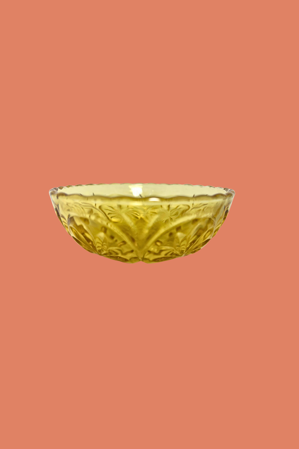 Decorative glass bowl on a peach background