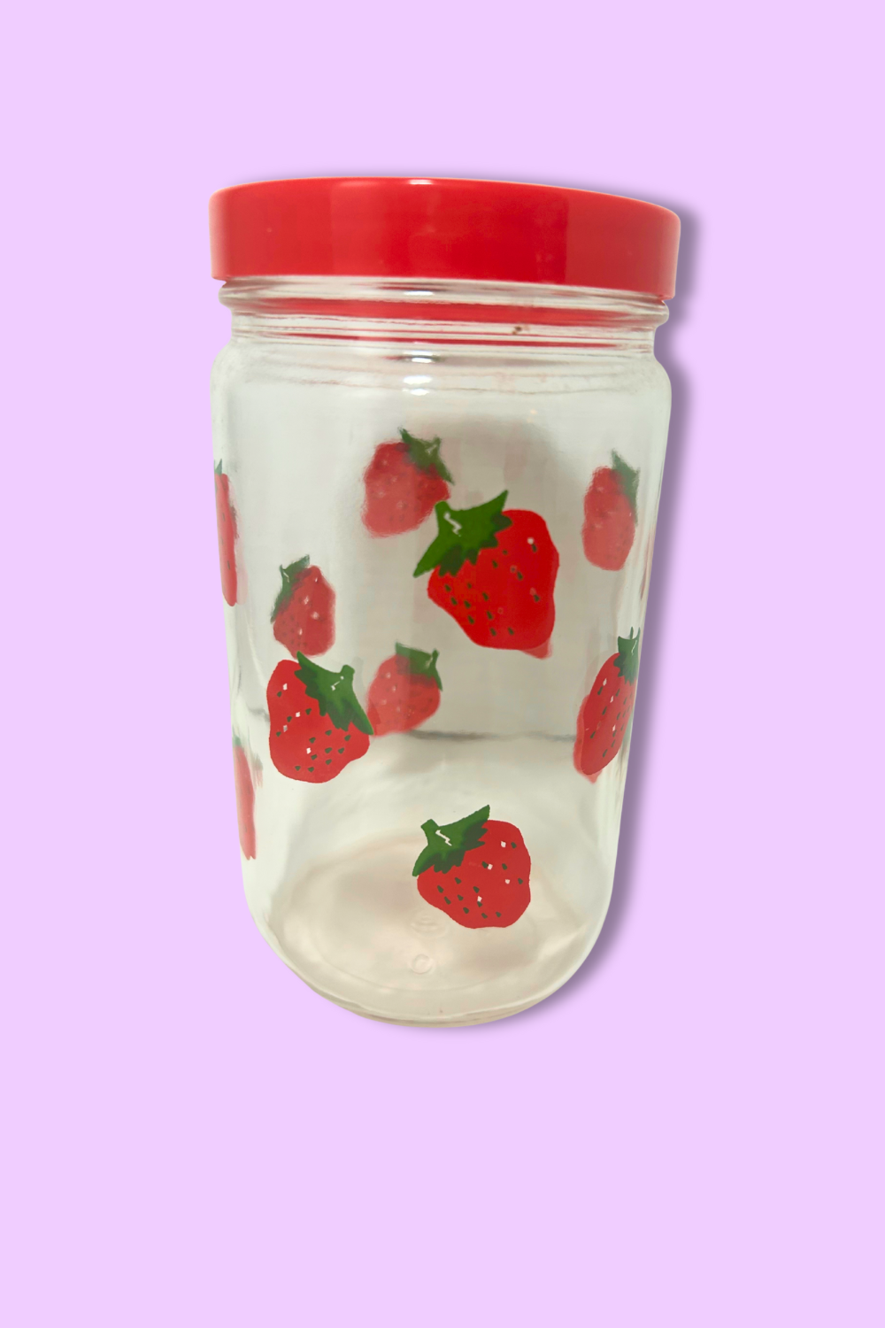 Clear tumbler with red lid featuring strawberry pattern on a purple background