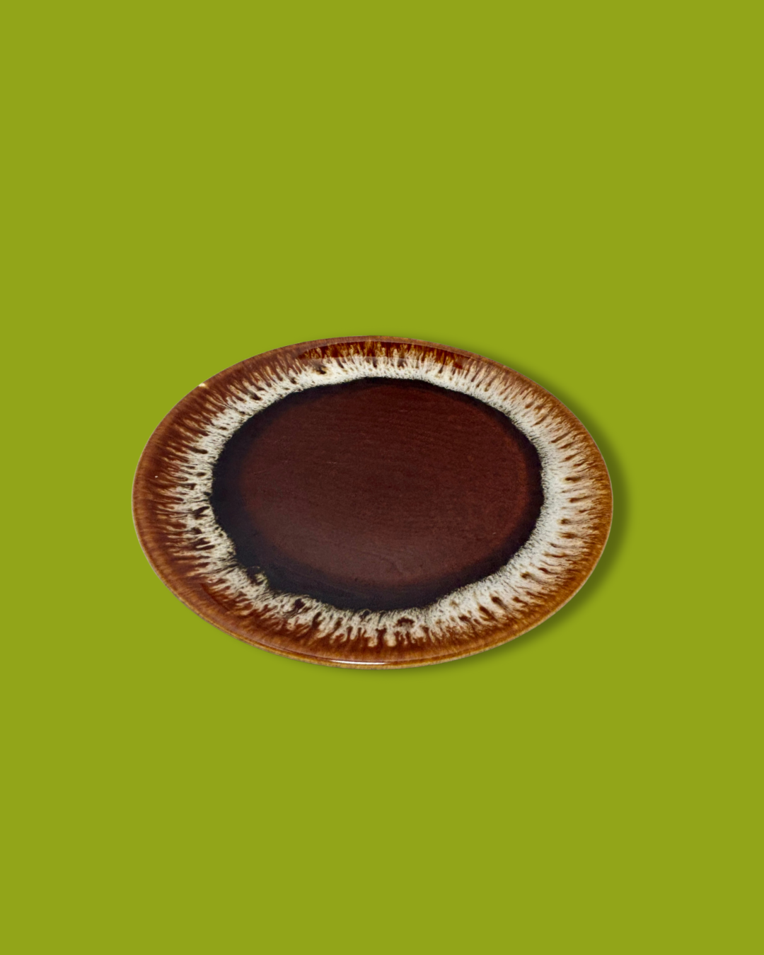 A single brown drip glaze salad plate with a vintage design, showcasing a dark brown center with a lighter brown rim.