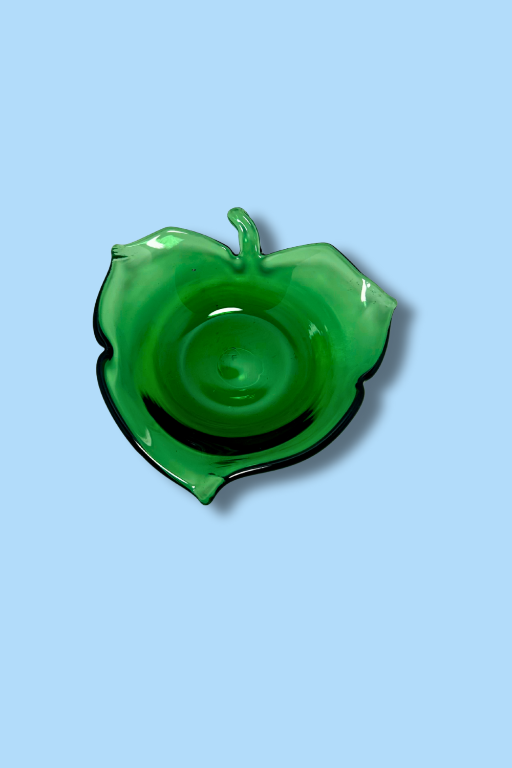Green Leaf shaped dish on a light blue background