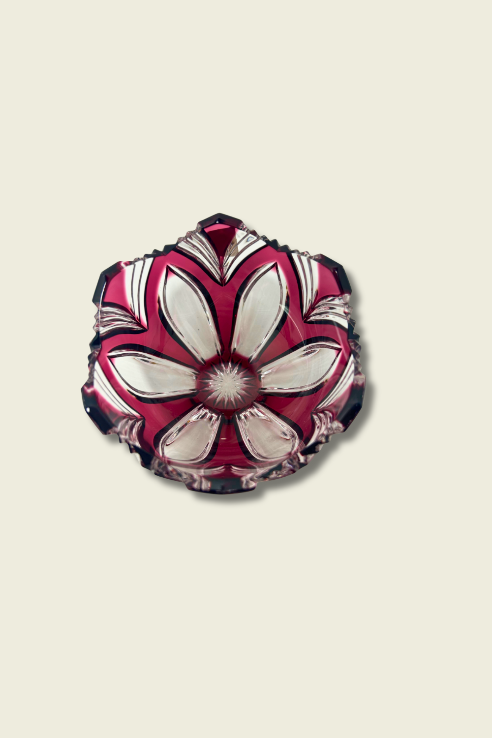 Decorative glass piece with floral pattern on a beige background