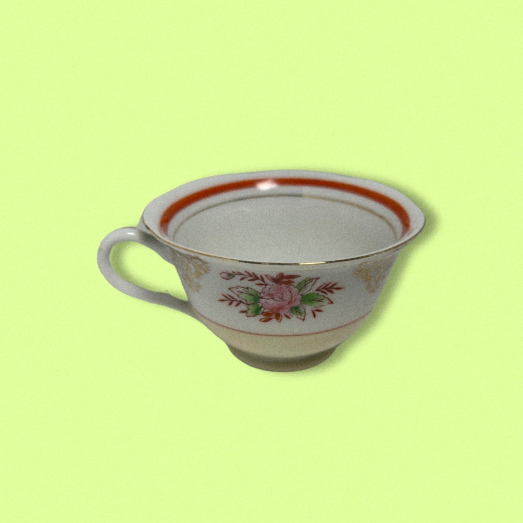 Photo of hand painted japanese tea cup on green background