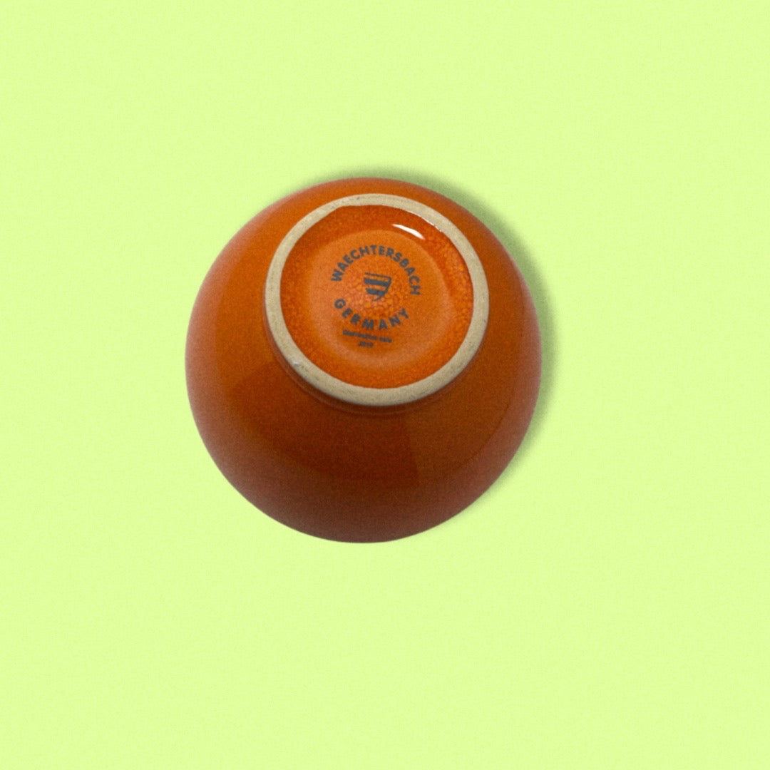 Photo of Stamp on bottom of vintage orange bowl.