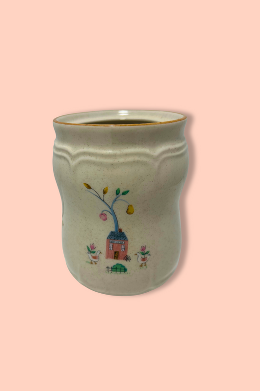 Ceramic mug with a decorative design on a pink background