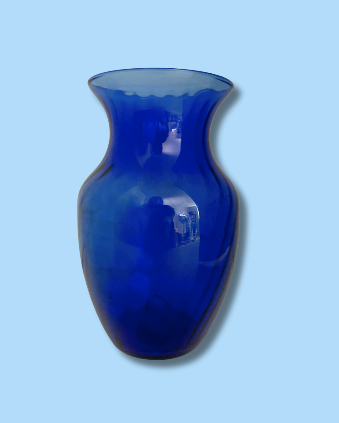 Blue glass vase on a light blue background