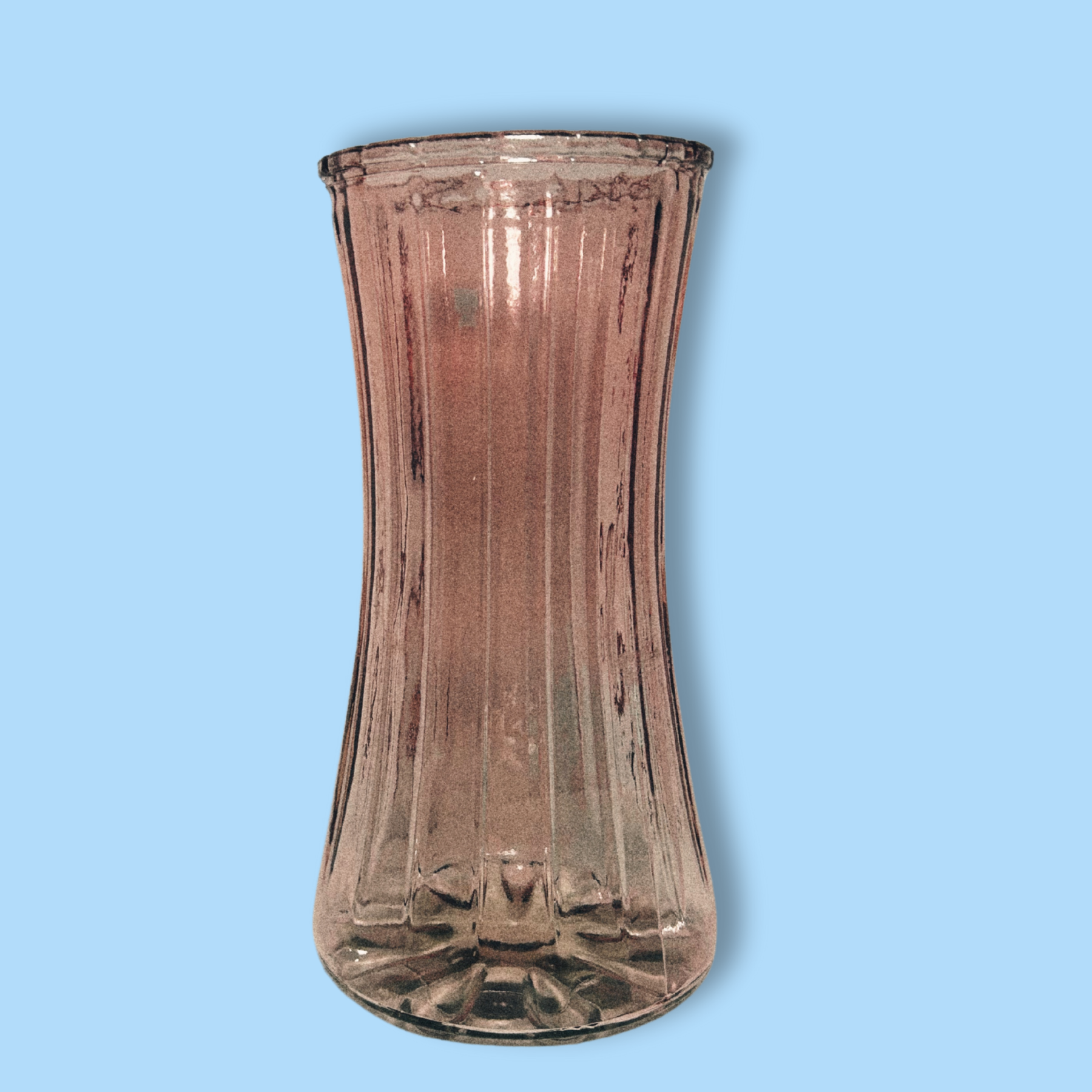 A vintage inspired pink glass vase with a ribbed design on a plain background.
