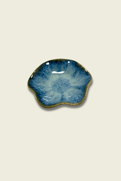 Blue ceramic dish on a beige background
