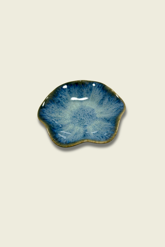 Blue ceramic dish on a beige background