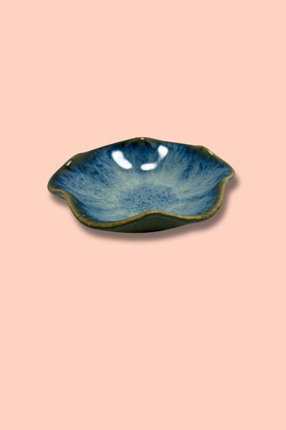 Blue ceramic dish on a pink background