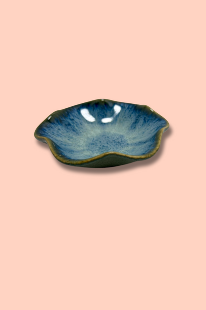 Blue ceramic dish on a pink background