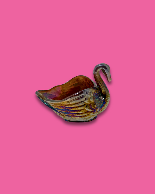 Ceramic swan-shaped dish on a pink background