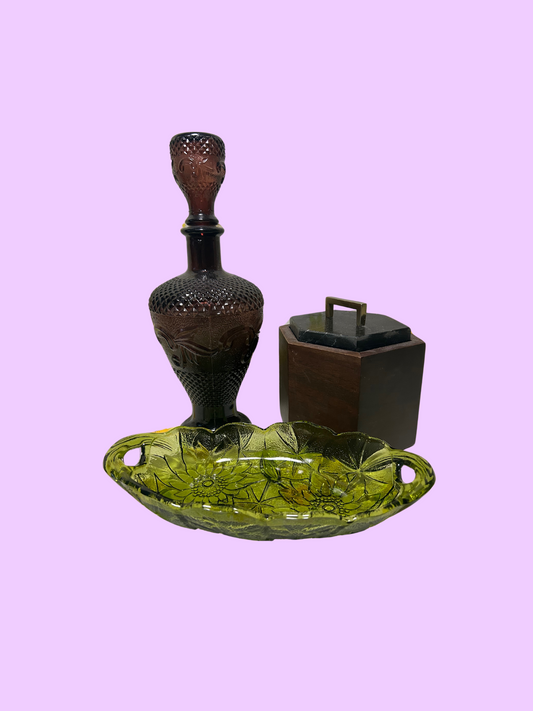Avocado green glass candy dish with a sunflower pattern on a purple background.
