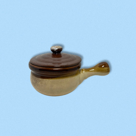 photo of vintage soup crock on blue back ground.