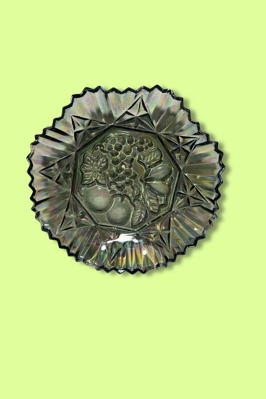 Decorative glass plate with fruit design on a light green background