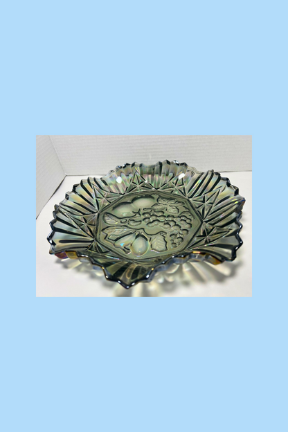Decorative glass bowl with leaf design on a white surface