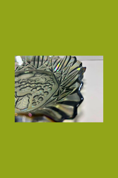 Decorative metal object with intricate design on a green background