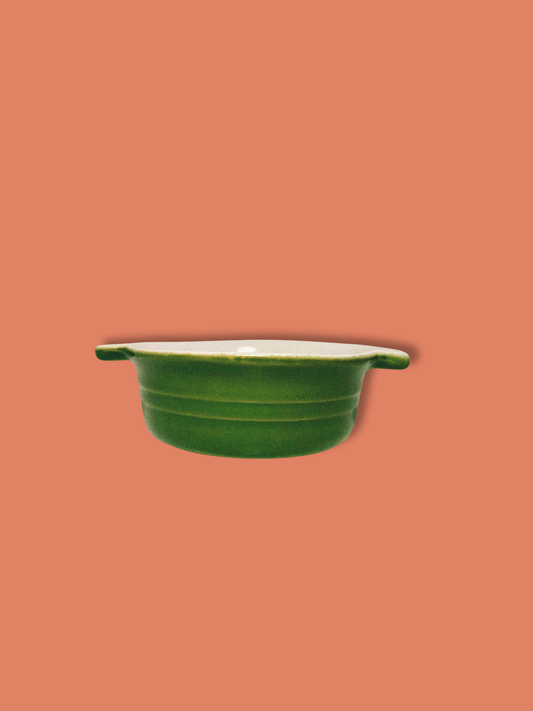 Photo of green baking dish on orange background