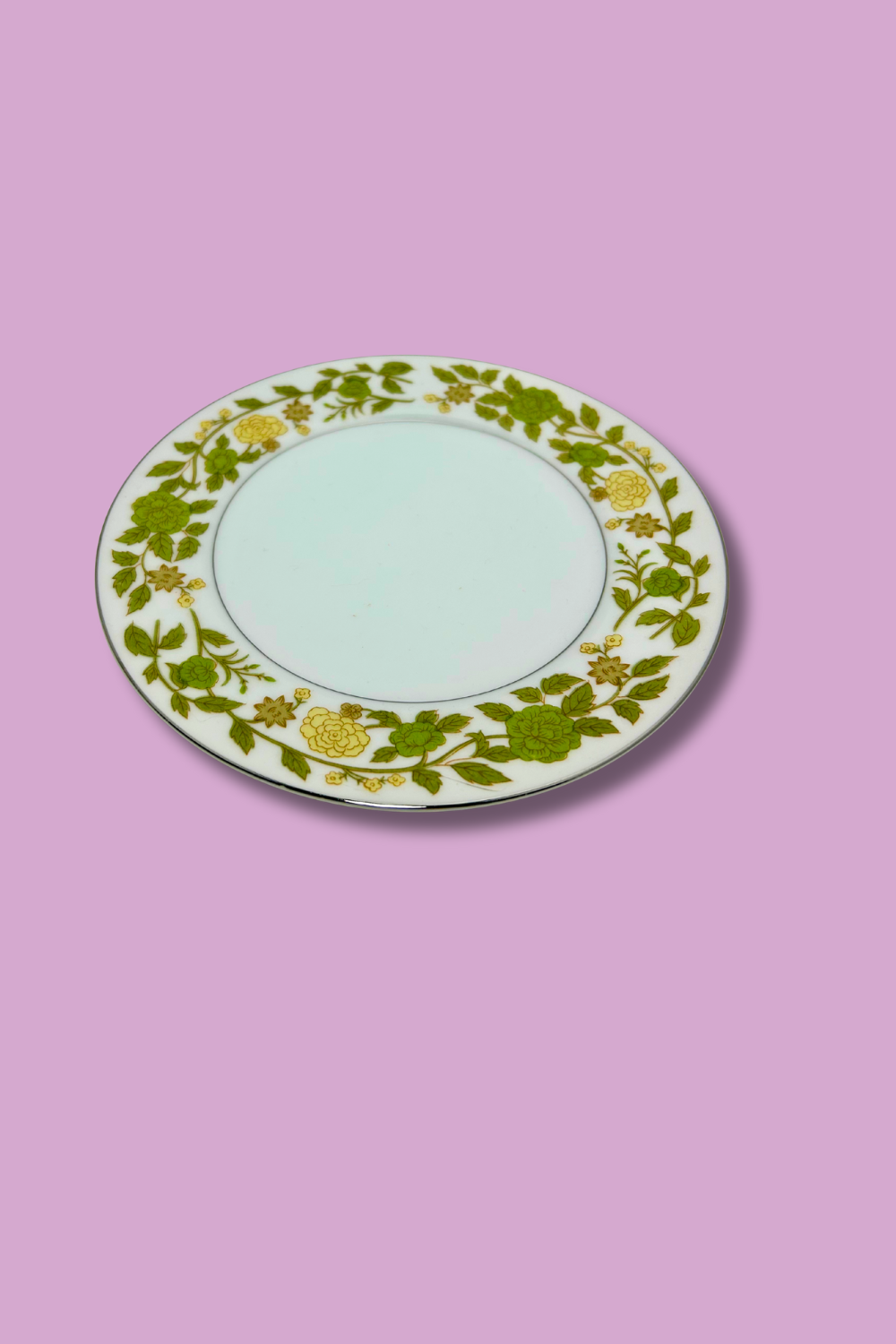 Decorative plate with floral pattern on a pink background
