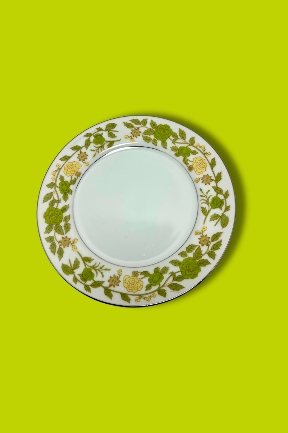 Decorative plate with floral pattern on a green background