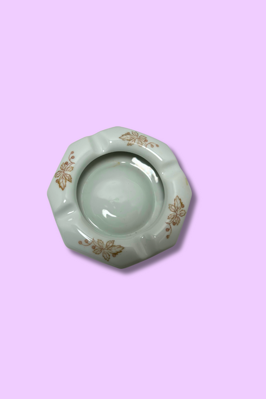 Decorative ashtray with floral patterns on a pink background