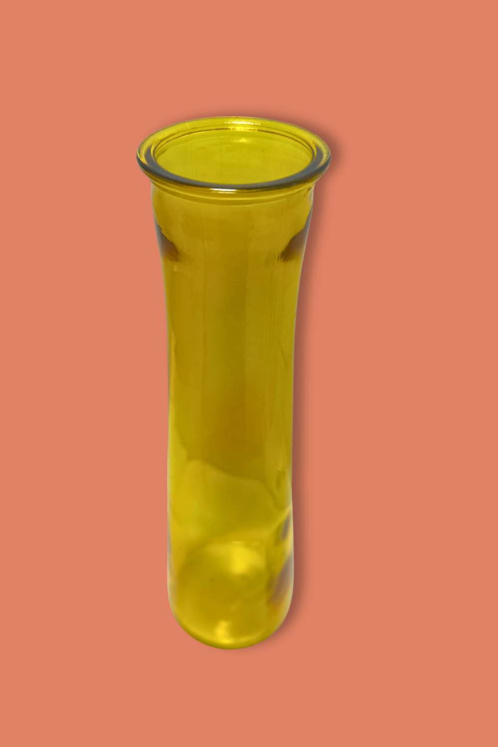 Yellow glass vase on a peach background