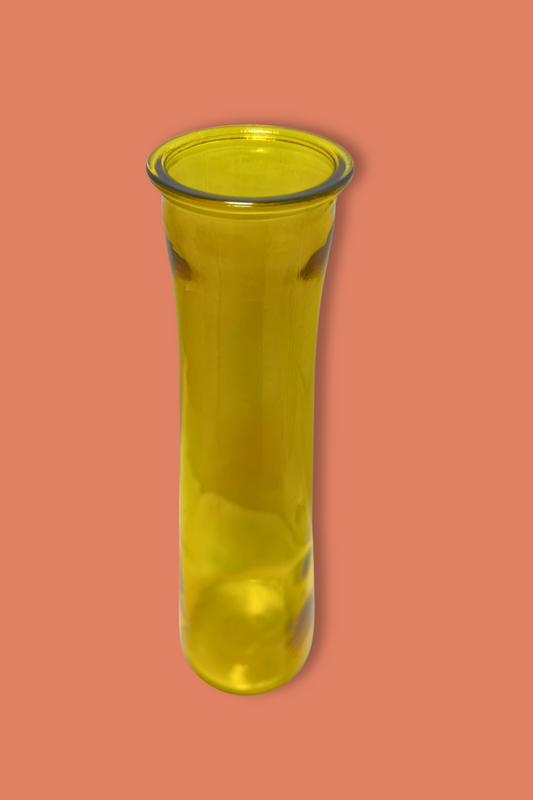 Yellow glass vase on a peach background