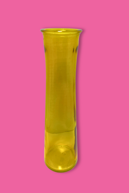 Yellow glass vase on a pink background
