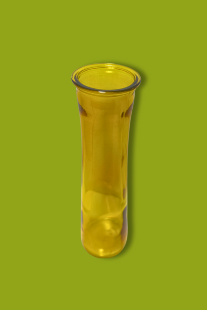 Yellow glass vase on a green background