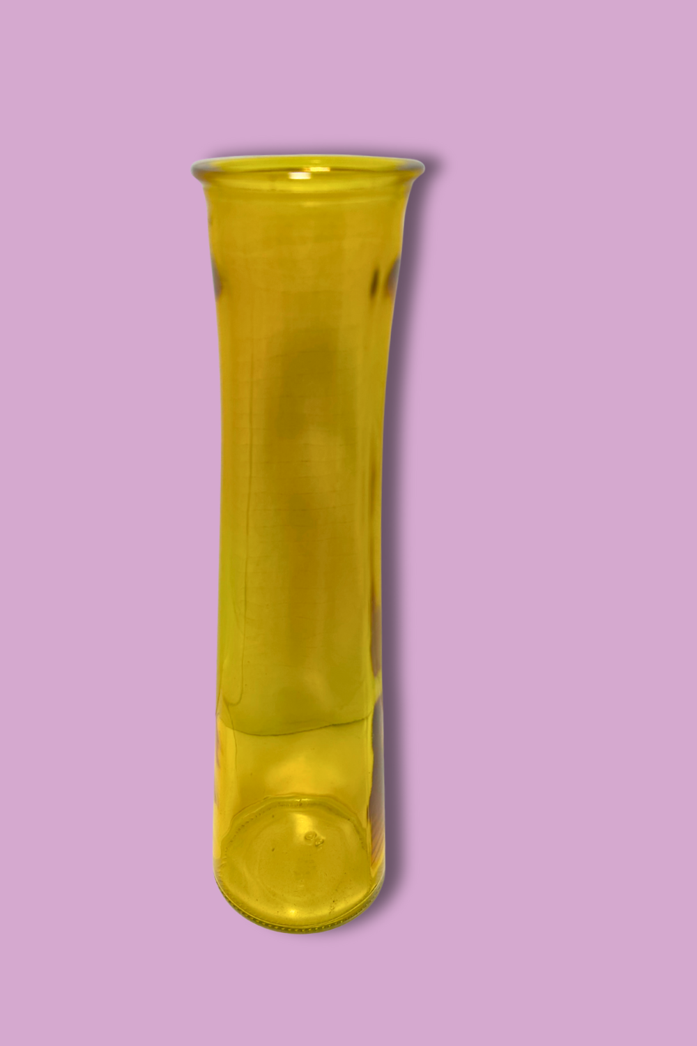 Yellow glass vase on a pink background