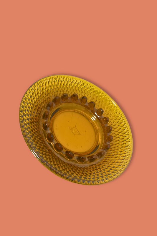 Gold decorative plate on a peach background