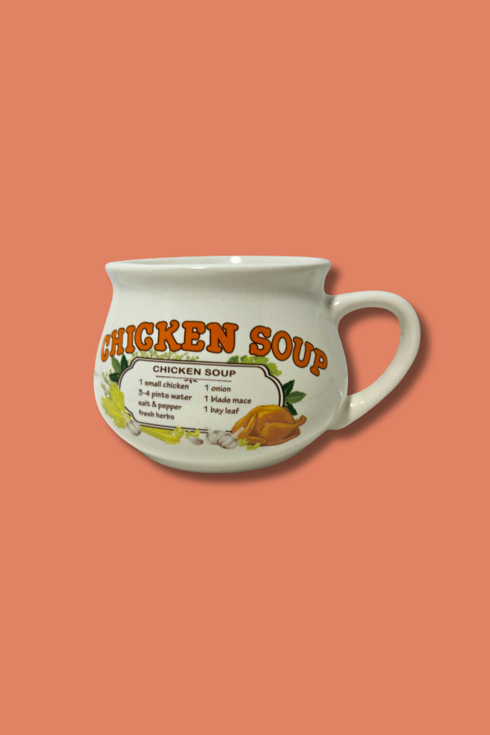 White mug with 'Chicken Soup' text and recipe on a peach background