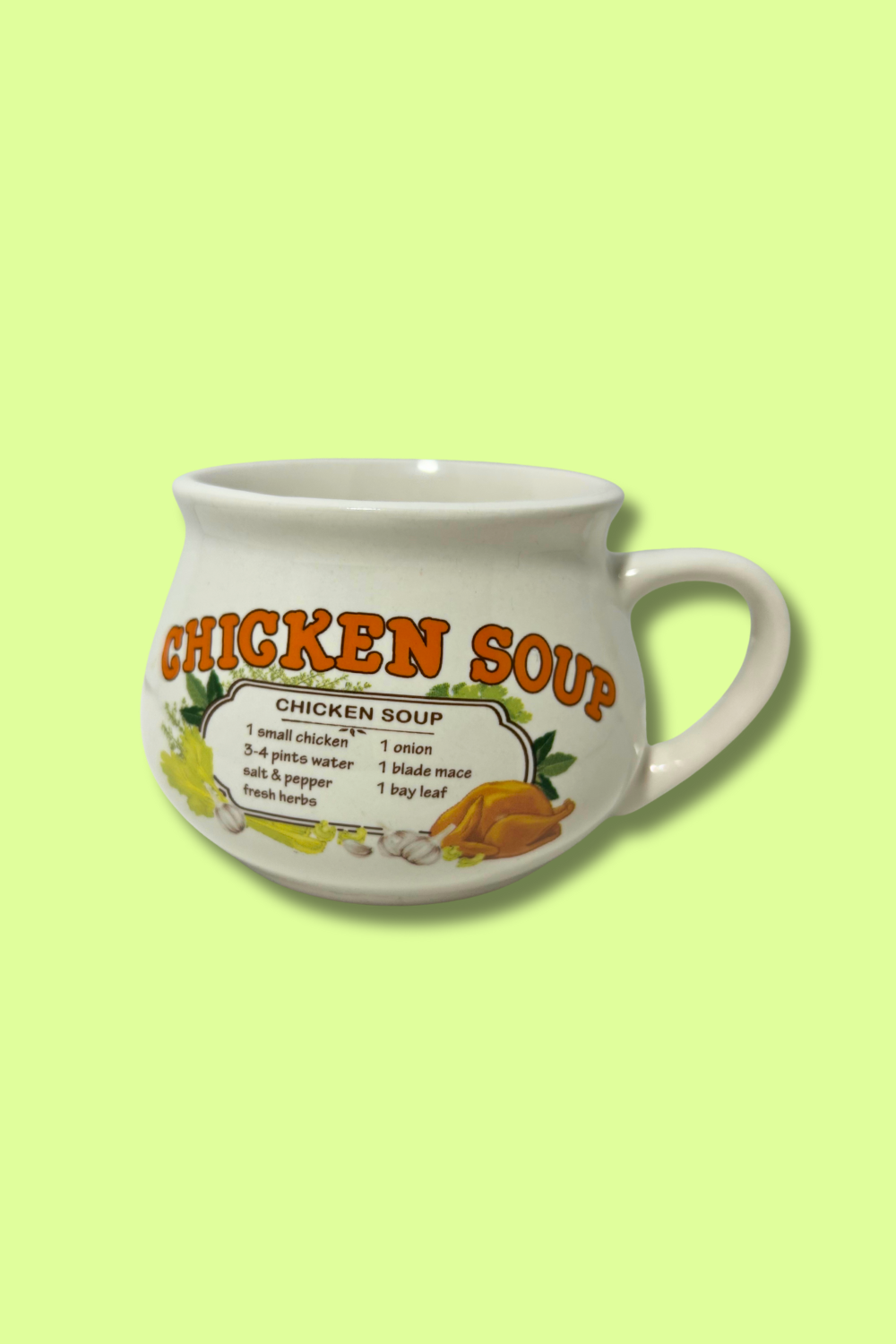 White mug with 'Chicken Soup' text and recipe on a green background
