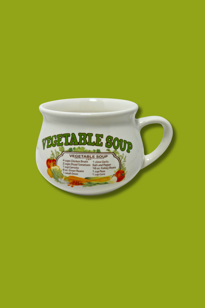 White mug with 'Vegetable Soup' text and graphics on a green background