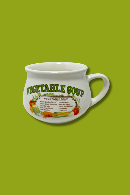 White mug with 'Vegetable Soup' text and graphics on a green background