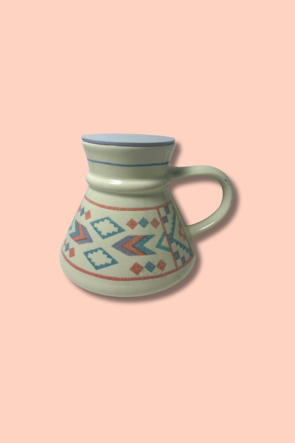 Ceramic mug with geometric pattern on a pink background